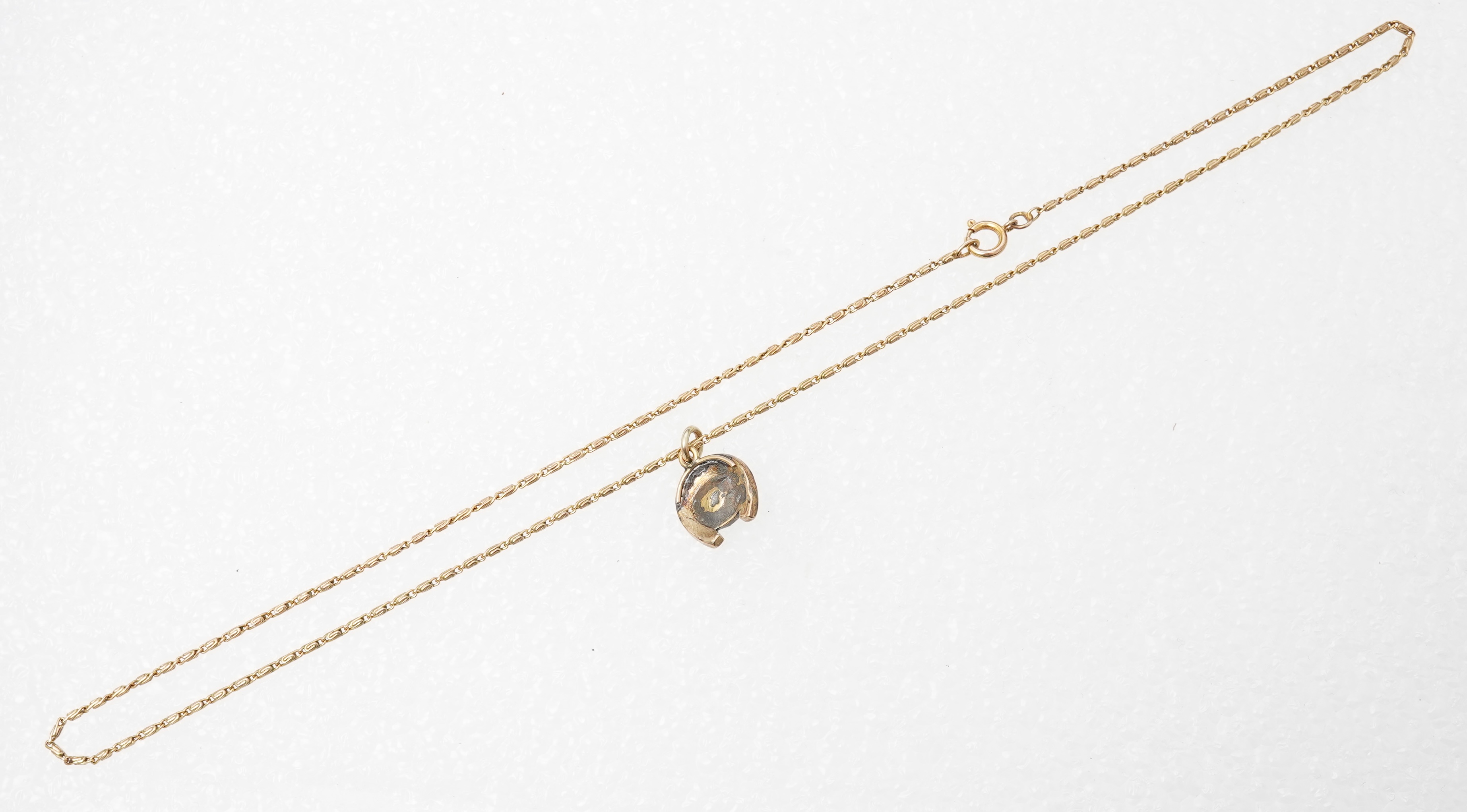 A yellow metal, cat's eye quartz and rose cut diamond cluster set horseshoe pendent, 11mm, together with a 9ct gold chain, 41cm, gross weight 5 grams.